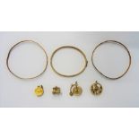 Four 9ct gold charms, comprising; a dart board, a penny farthing bicycle,