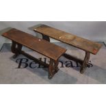 A pair of early 20th century oak benches on duel end supports, 105cm wide x 48cm high, (2).