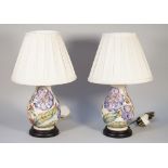 A pair of Moorcroft Pottery table lamps, tube line decorated with hibiscus against a cream ground,