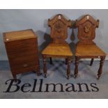 A pair of Victorian and later oak and elm shield back hall chairs,