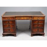 A George III style mahogany pedestal desk with nine drawers about the knee on ogee bracket feet,