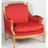 A large Louis XVI style gilt framed armchair with bow seat on tapering fluted supports,