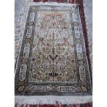 A Chinese silk tree of life rug, the ivory field filled with an abundantly floral tree,