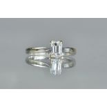 A white precious metal and single stone diamond ring,