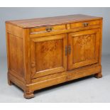 An early 19th century French figured oak buffet with a pair of drawers over panel cupboards on