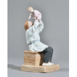 A Russian biscuit porcelain figure group of a father and child, Gardner factory, late 19th century,