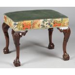 A George II style mahogany framed rectangular footstool on shell capped claw and ball supports,