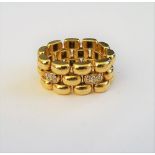 A gold and diamond chain link ring, in a three row domed oval link design,