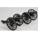 A pair of modern cast iron scale model cannon, each with spoked wheels and turned barrel, 71cm, (2).