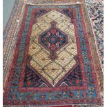A Hamadan rug, Persian, the fawn trellis field with an indigo medallion,