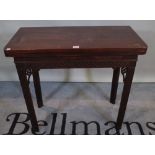 A late George III mahogany fold over card table with fret cut decoration, 80cm wide x 73cm high.