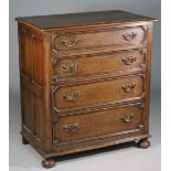 A Charles II style oak chest with four long graduated geometric moulded drawers on bun feet,
