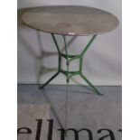 A 20th century French occasional table, the polished metal circular top on a green painted base,
