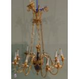 An ebonised and gilt brass Empire style nine branch chandelier, 20th century,