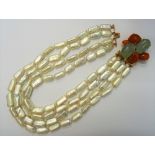 A graduated four row cultured pearl necklace, the clasp designed as a brooch,