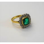 An 18ct gold, emerald and diamond dress ring, of cluster design,