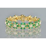 A gold, emerald and diamond bracelet, in a shaped circular cluster link design,