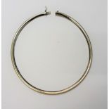 A white gold collar necklace, of curved link design, to a concealed box and tongue clasp,