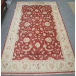 A European carpet, the madder field with large all over floral design,