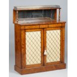 An early Victorian pollard oak side cabinet with mirrored ledge back over a pair of brass grille
