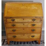 An early 20th century oak and elm fronted bureau with four ong graduated drawers.