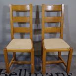 A set of eight 20th century oak ladderback dining chairs on block supports, (8).