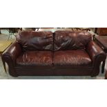 A pair of 20th century hardwood framed faux brown leather upholstered sofas, 210cm wide x 80cm high.