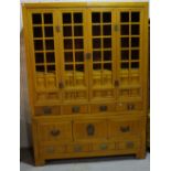 A mid 20th century Chinese style beech side cabinet with eight short drawers,