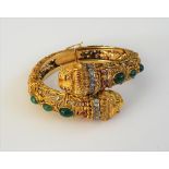 An emerald, ruby and diamond hinged bangle by Ilias Lalaounis,