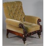 An early Victorian easy armchair with roll over arms and profusely carved mahogany frame,