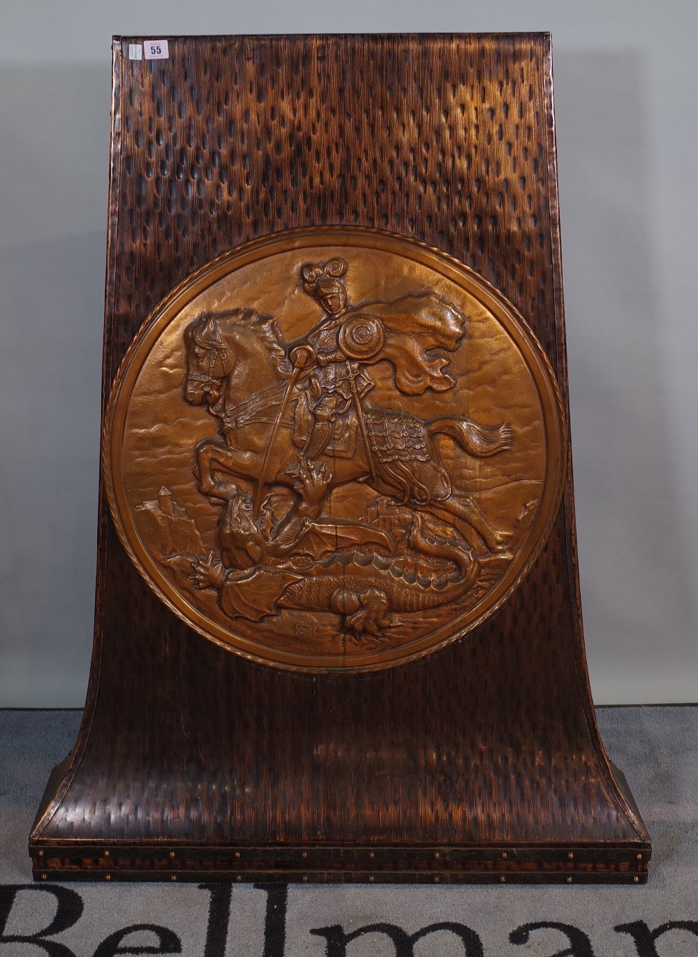 An early 20th century copper stand with circular embossed panel of George and the Dragon,