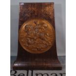 An early 20th century copper stand with circular embossed panel of George and the Dragon,