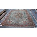 A Heriz carpet Persian, the pale indigo field with a bold madder and sage medallion,
