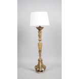 An 18th century gilt-wood altar candlestick (converted into a table lamp), carved foliate detail,