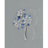 A white gold, sapphire and diamond brooch, designed as a triple flowerhead shaped spray,