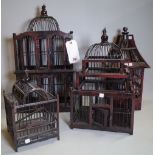 A group of four 20th century black lacquer and hardwood bird cages of various forms, the largest,