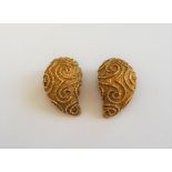 A pair of yellow precious metal earclips, of domed and reeded tear drop design,