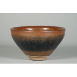 A Song style `hares fur' bowl, covered in a black and brown glaze falling short of the foot,