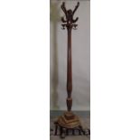 A Regency style mahogany coat stand with reeded column on circular plinth base and pad feet,