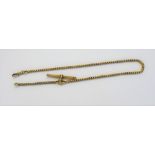 A French gold serpentine link watch Albert chain, fitted with a ridged T bar and with a swivel,