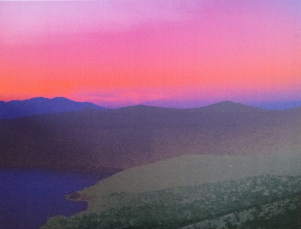 An oleograph print of a sunset landscape, indistinctly signed and dated '07 on overlap, unframed,