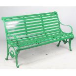 A 19th century green painted cast-iron garden bench with wooden slatted seat,