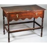 A Queen Anne oak side table with single frieze drawer on turned supports united by high perimeter