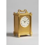 An English giltmetal carriage timepiece Circa 1870 The rectangular case with shaped handle and