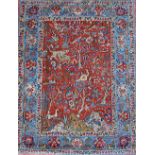 A Tabriz rug, Persian, the madder field with a landscape of hills and trees, tigers, lions,