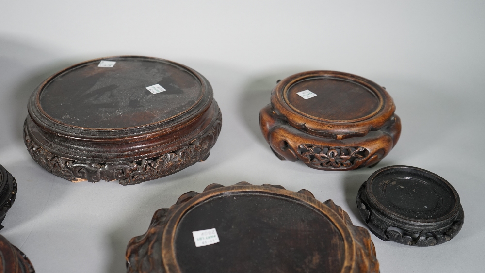 A group of nineteen Chinese wood stands, 19th/20th of various forms, 9cm to 25cm diameter, (19). - Image 5 of 6