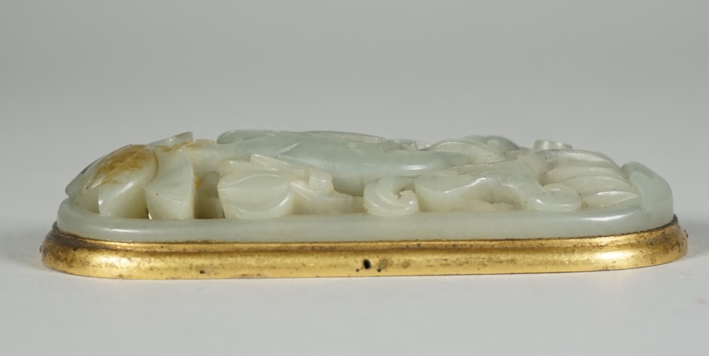 A Chinese celadon jade plaque, probably 17th/18th century, set with a gilt-metal mount, - Image 4 of 4