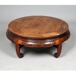 An early 20th century Chinese hardwood circular low table on five inswept supports,
