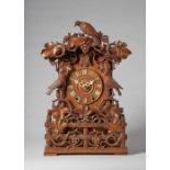 A Tyrolean carved walnut striking fusée cuckoo mantel clock By Aron Ketterer, Furtwangen,