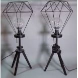 A pair of 20th century black painted tripod lamps with wire work shades, 75cm high, (2).